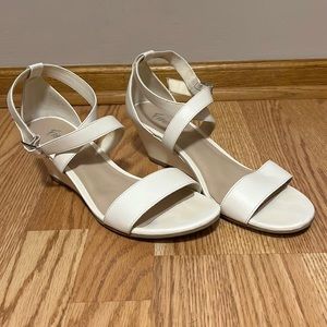 White steeply wedge heel sandals